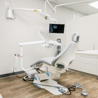 Dental treatment room with desk and chairs