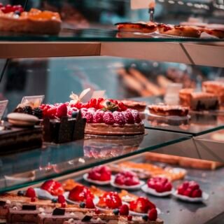 Fruit tarts and chocolate cakes in a bakery display